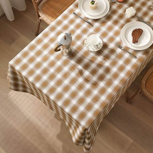 Rectangular checked tablecloth made of cotton blend with pom-pom corners