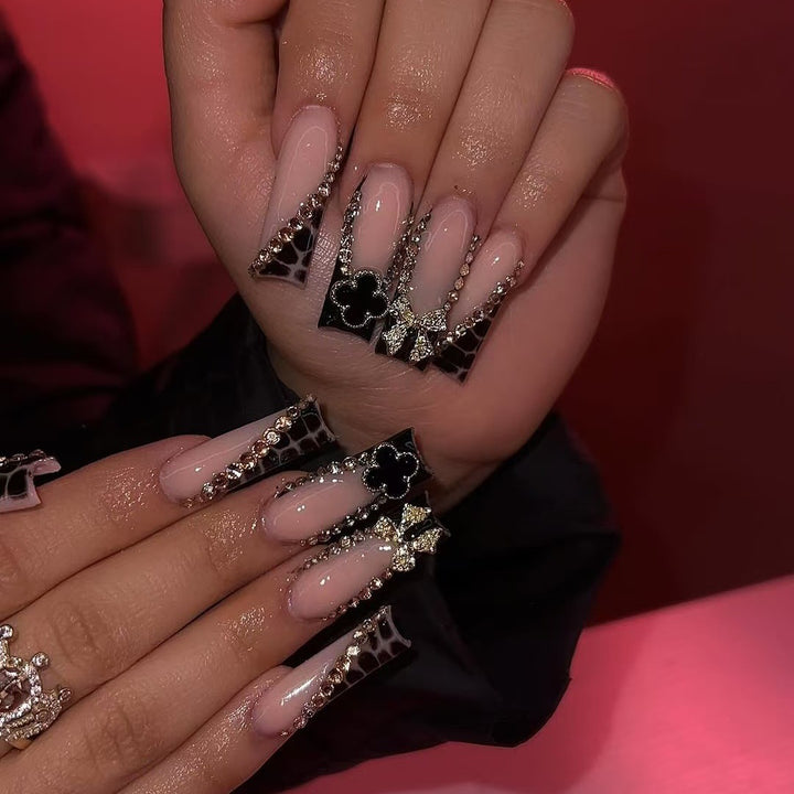 Glamorous artificial nails with elegant design with rhinestones and 3D decorations Bowlift