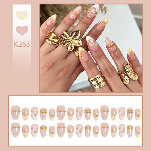 Artificial nail set with enchanting floral details and luxurious gold accents Bowlift