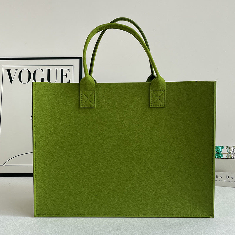 Structured felt tote bag with reinforced handles and organized interior Bowlift