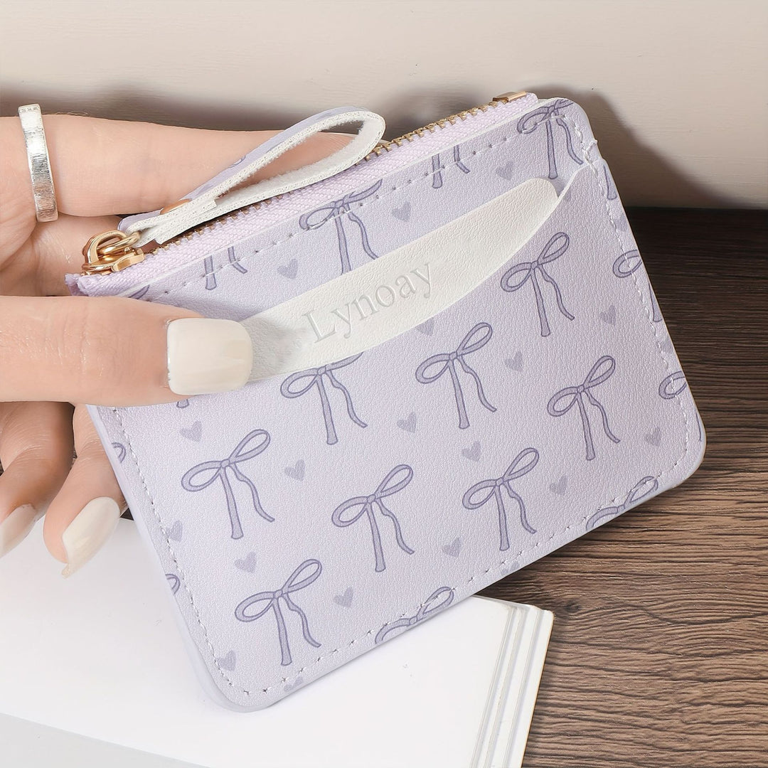 Compact bow-print coin purse wristlet with zipper closure Bowlift