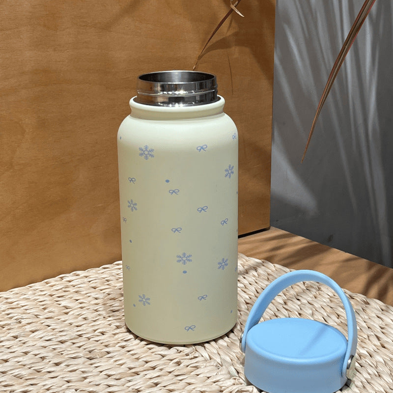 Women's insulated drinking bottle with practical carrying handle and cheerful design Bowlift