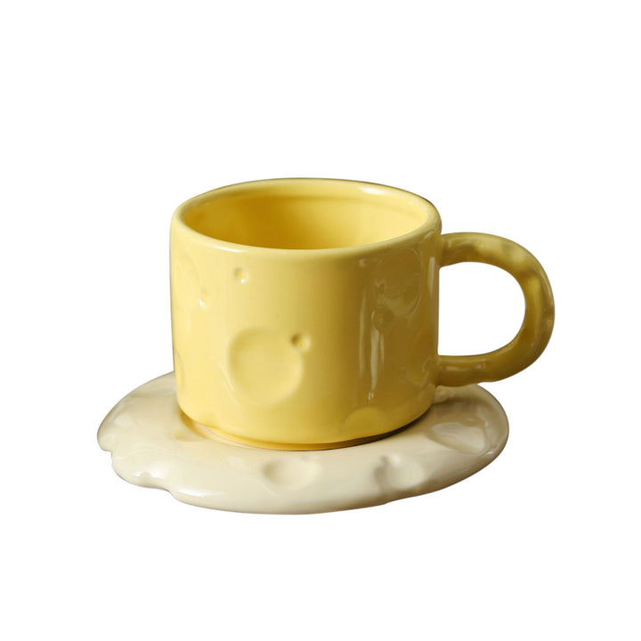 Sculptural ceramic cup set with flowing glaze and textured saucer