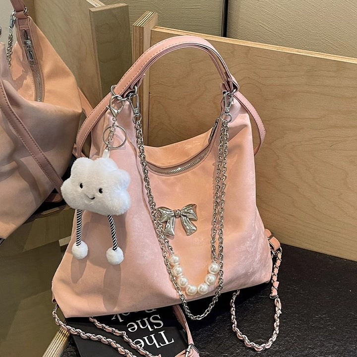 Fashionable handbag with unique pendant and chain accents Bowlift