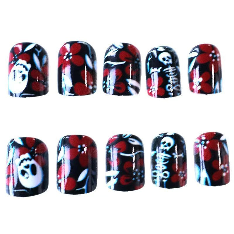 Creative nail art with skull motif and floral elements Bowlift