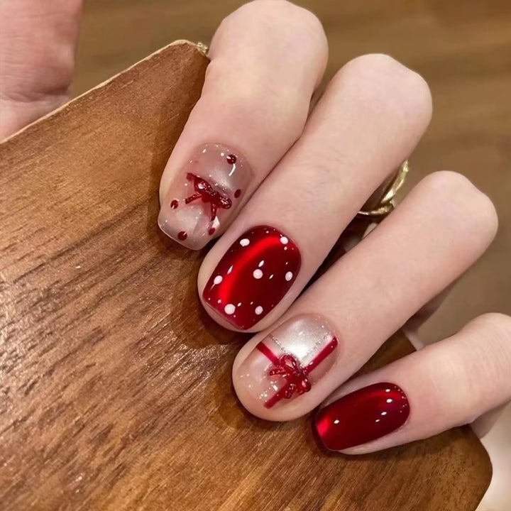 Artificial nail set with festive gift design and elegant glitter accents Bowlift
