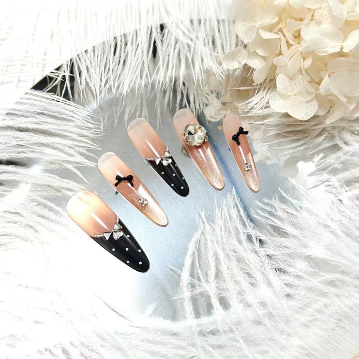 Elegantly designed artificial nails in luxurious design with decorative rhinestone applications Bowlift