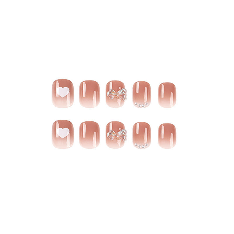 Artificial nails with romantic hearts and glitter accents Bowlift