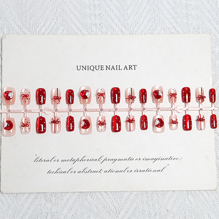 Artificial nail set with festive gift design and elegant glitter accents Bowlift