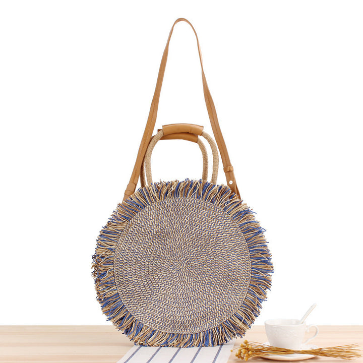 Round bag with fringe decoration Made of woven material Bowlift