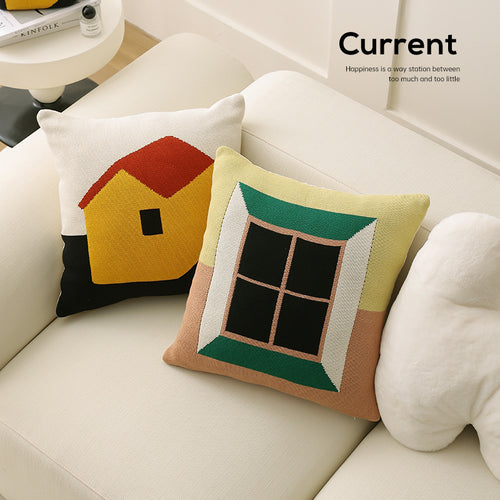 Geometric knit pillow with triangle pattern and logo patch