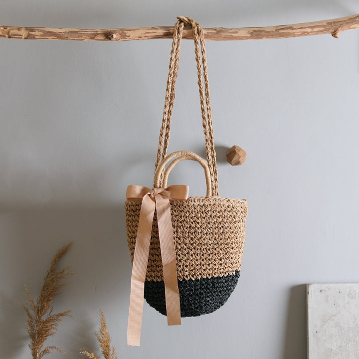 Basket bag with stylish carrying handles and decorative bow Bowlift