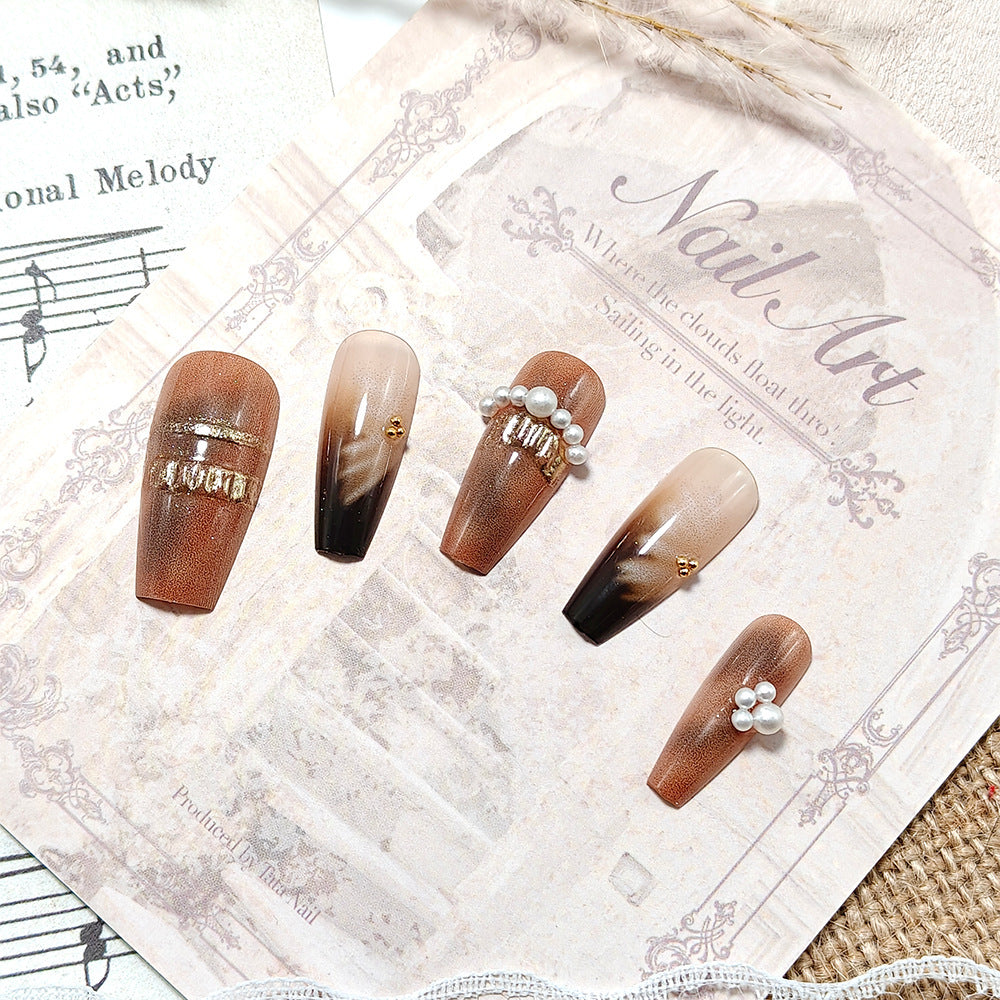 Artificial nails with glamorous gold and pearl embellished accents Bowlift