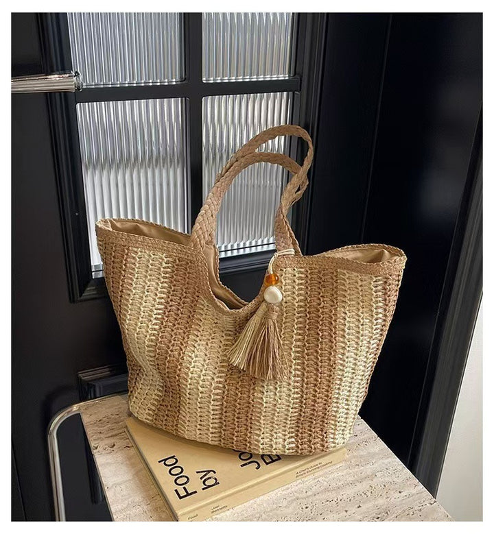 Handcrafted straw bag with elegant tassels and detailed texture Bowlift
