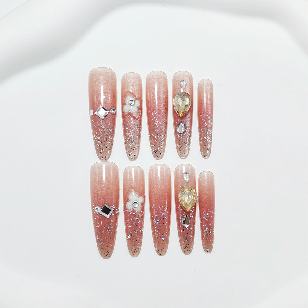 Artificial nail set with glitter and flower accents Bowlift