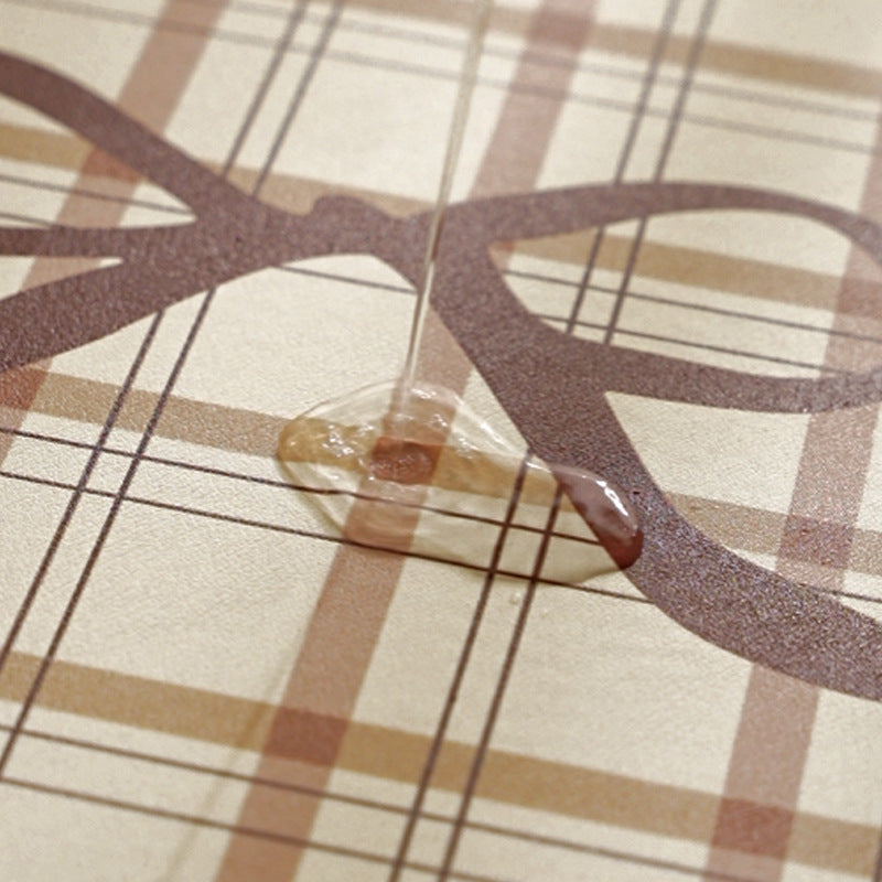Rectangular wipeable placemat with checked pattern, wavy decorative edge and bow motif Bowlift