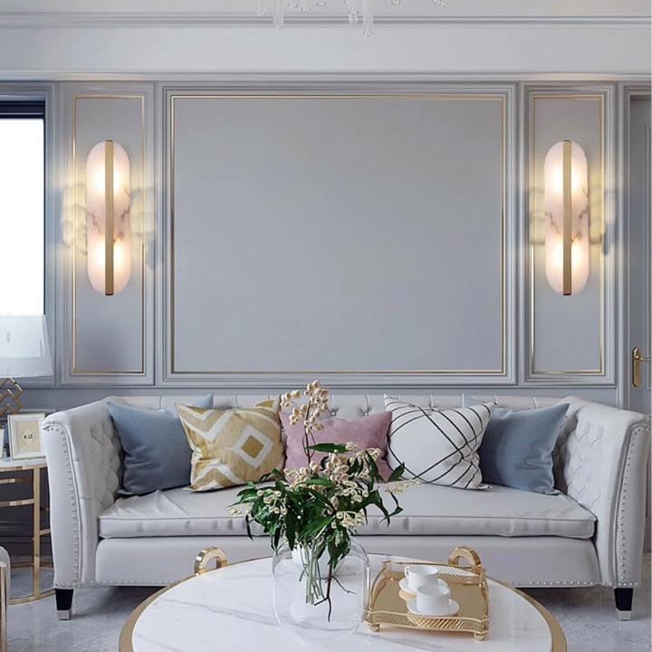 Modern marble oval wall sconce with brass accent and dual pin lamp holders Bowlift