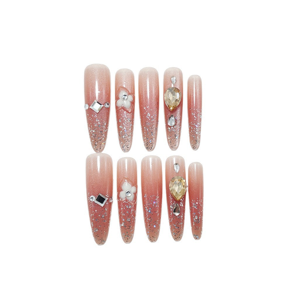 Artificial nail set with glitter and flower accents Bowlift