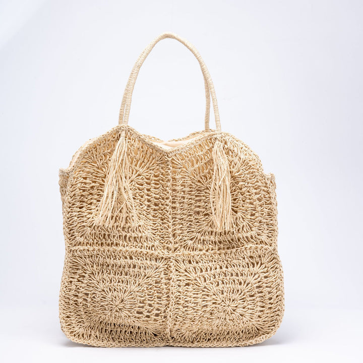 Spacious handbag made of braided natural material with fringes Bowlift