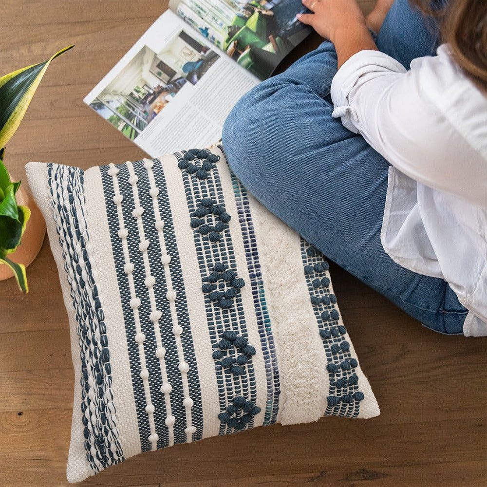 Structured decorative pillow with tufted diamonds, relief border, and corner tassels
