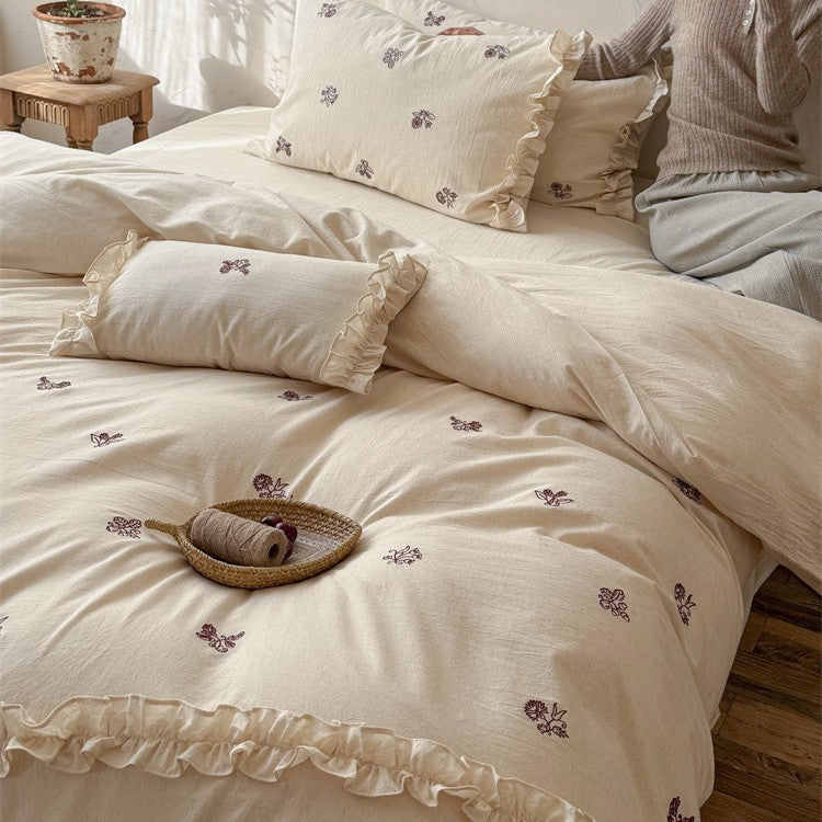 Cotton bedding set with embroidered floral motif and ruffled frills Bowlift