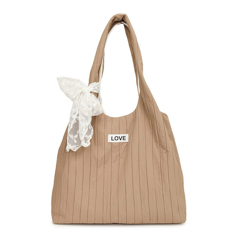 Leisure bag with structured design and playful scarf Bowlift