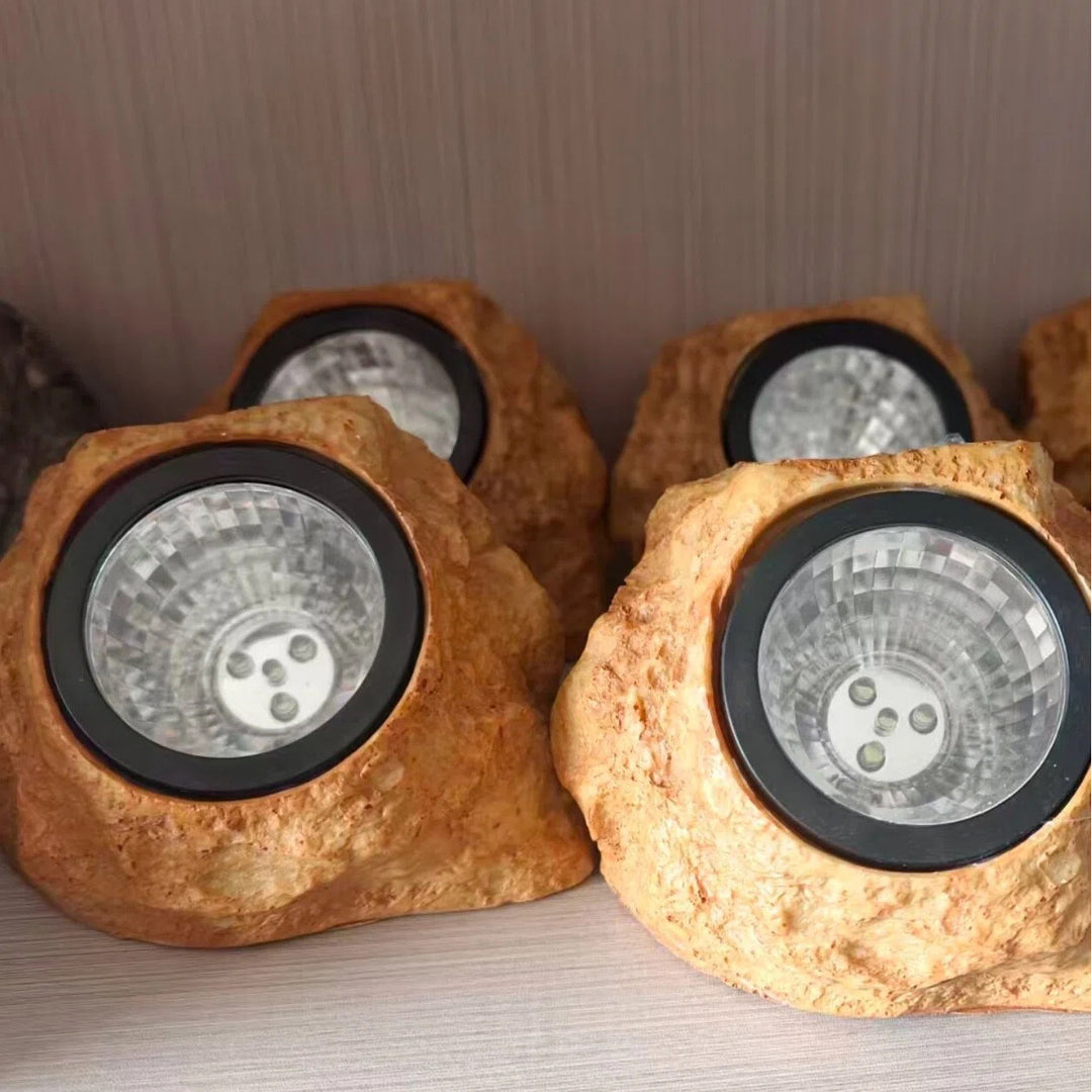Solar powered faux stone garden spotlight with high efficiency LED array Bowlift