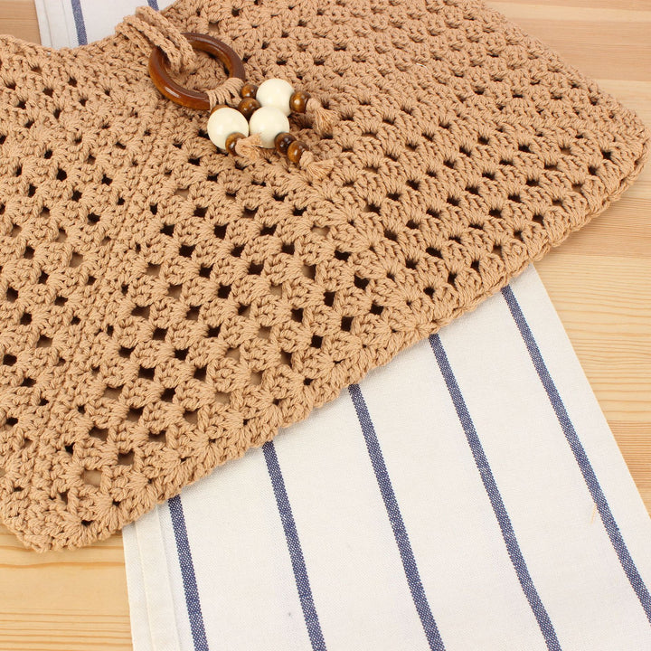 Handbag made of hand-knotted natural material with chic tassel decoration Bowlift