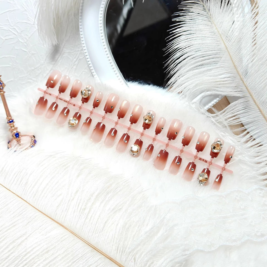 Artificials nails in elegant ombre style with rhinestone embellished applications Bowlift