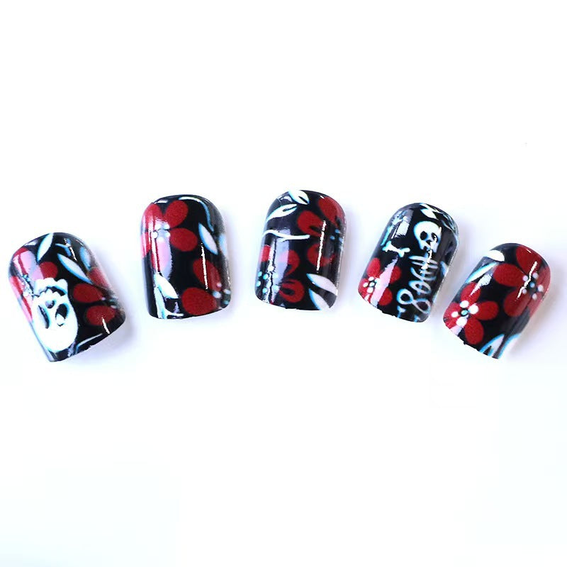 Creative nail art with skull motif and floral elements Bowlift