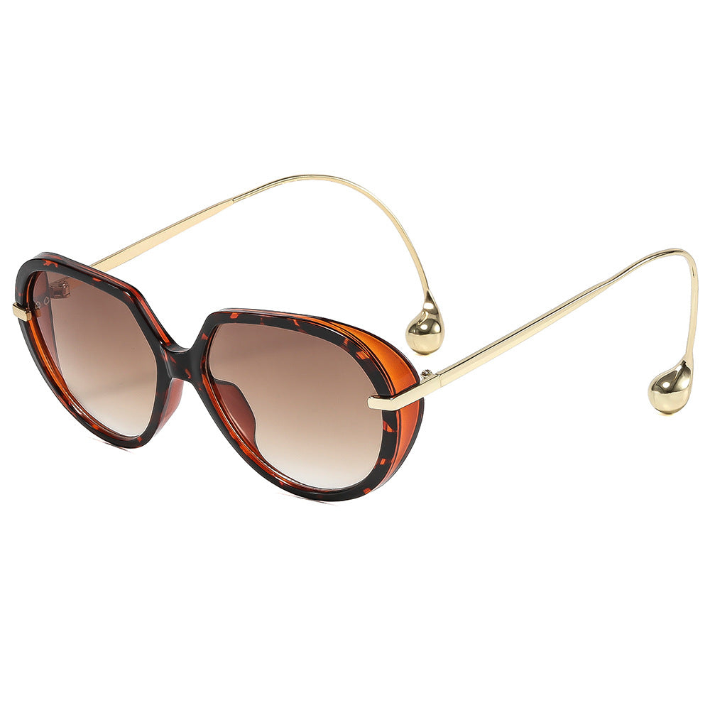 Women's Cat-Eye Sunglasses with Golden Accents and Stylish Frame Bowlift