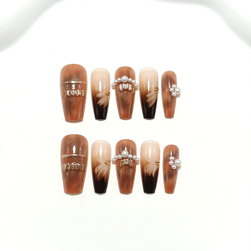 Artificial nails with glamorous gold and pearl embellished accents Bowlift