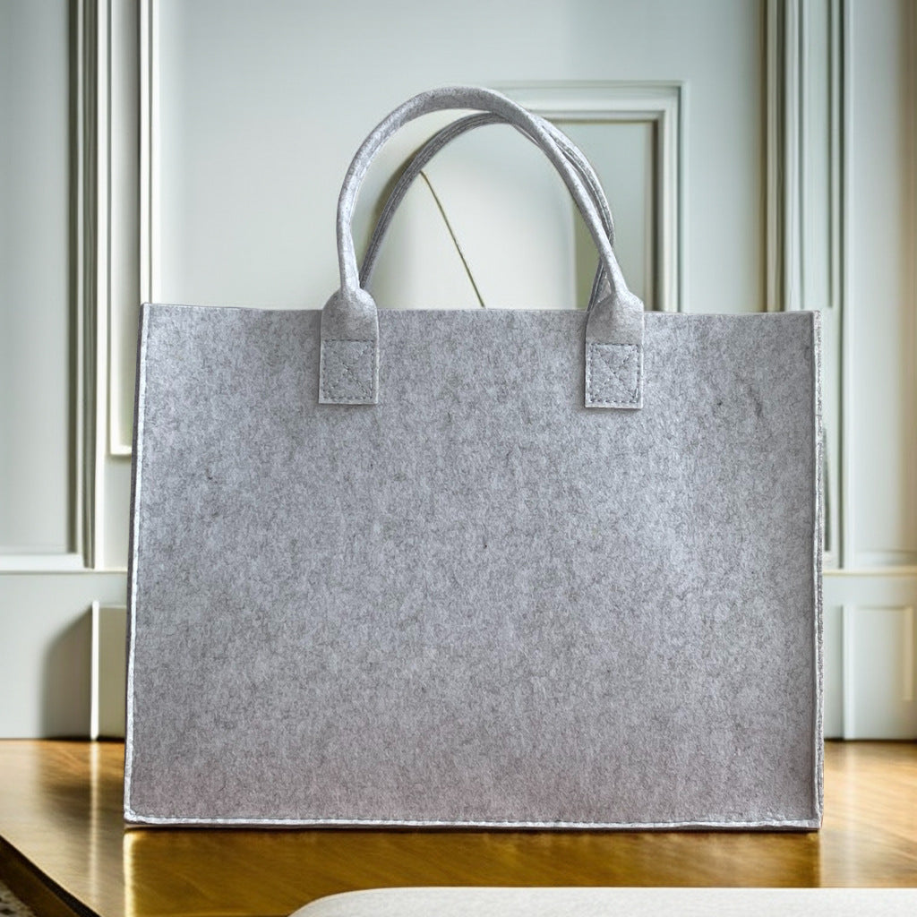 Structured felt tote bag with reinforced handles and organized interior Bowlift