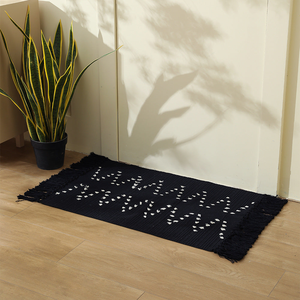 handwoven living room rug with fringes and geometric perforated pattern Bowlift