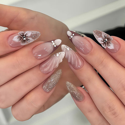 Artificial nails in elegant floral design with glitter accents Bowlift