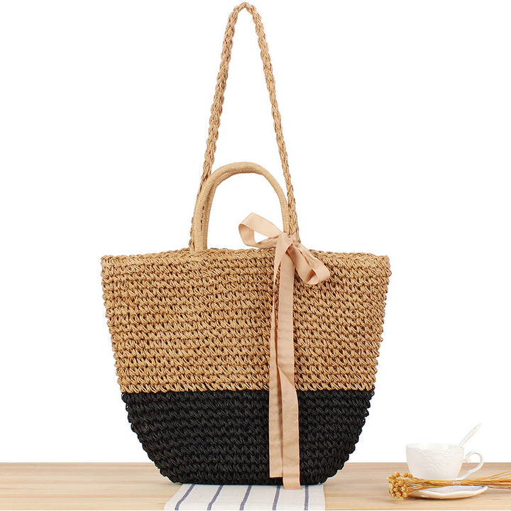 Beach bag made of natural raffia with playful design and elegant bow decoration Bowlift