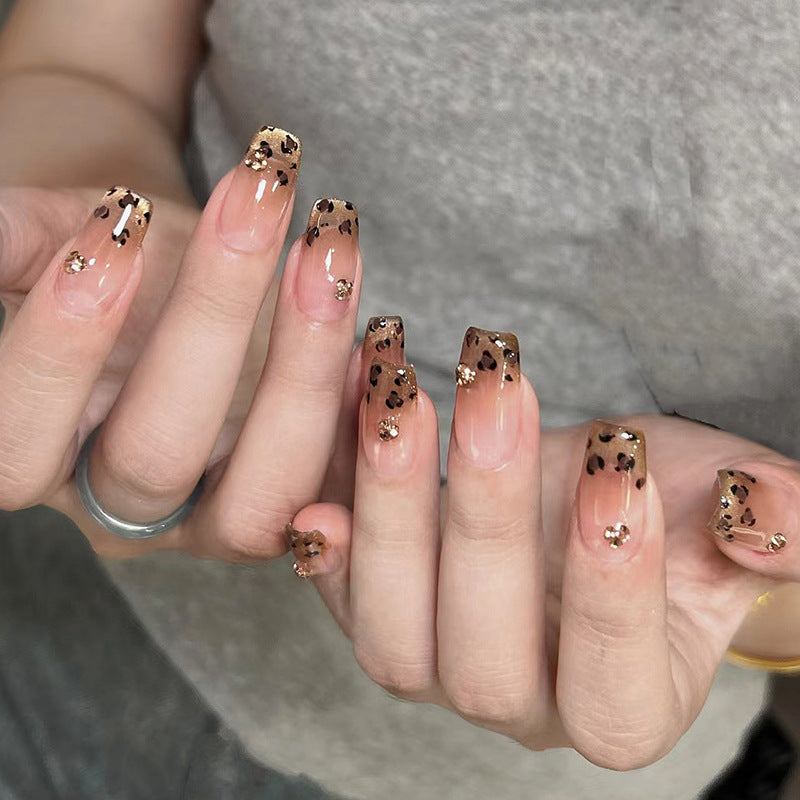 Artificial nails with shimmering leopard design and elegant accents Bowlift