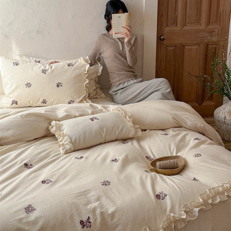 Cotton bedding set with embroidered floral motif and ruffled frills Bowlift