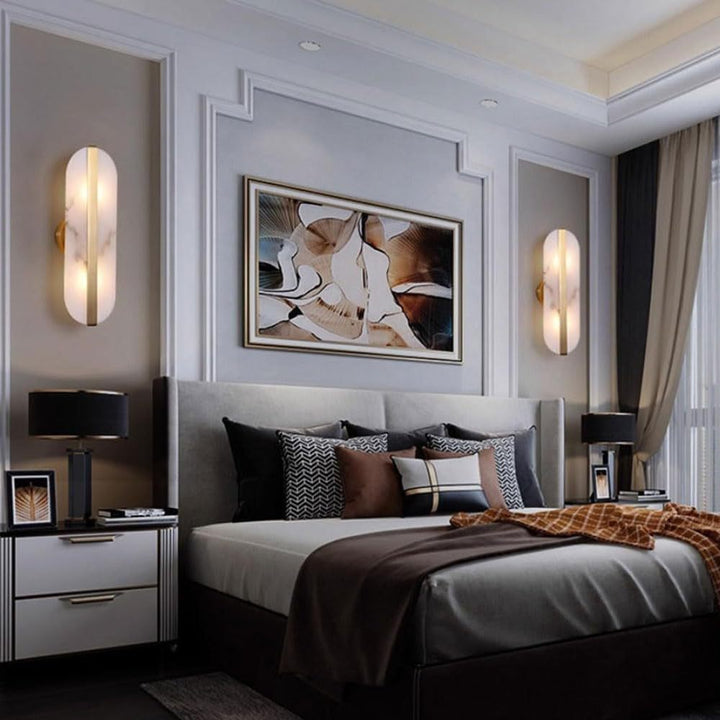 Modern marble oval wall sconce with brass accent and dual pin lamp holders Bowlift