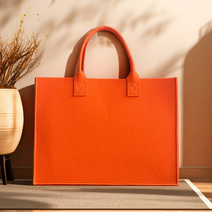 Structured felt tote bag with reinforced handles and organized interior Bowlift