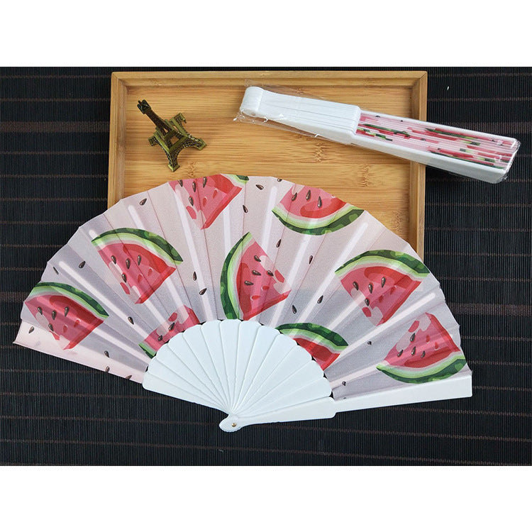 Women folding hand fan with shimmering scale pattern Bowlift