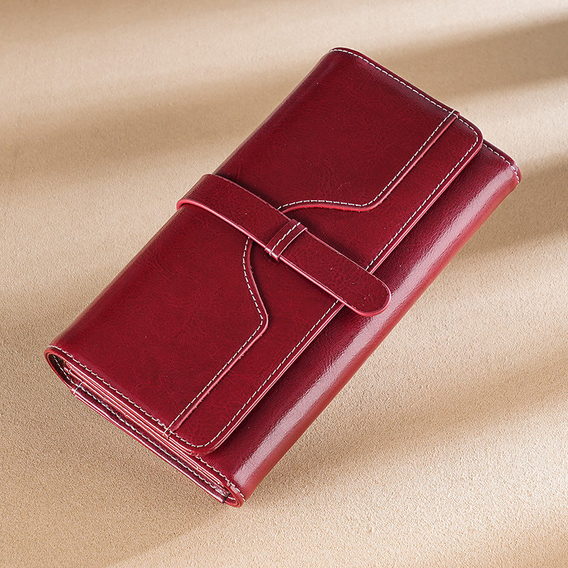 Premium leather long wallet clutch with strap closure and multiple card slots Bowlift