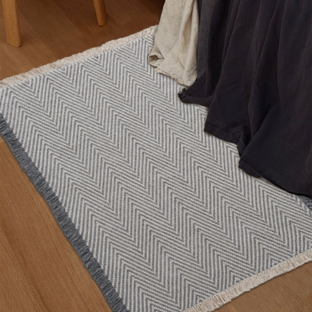 Handwoven cotton bath mat with herringbone pattern and fringes Bowlift