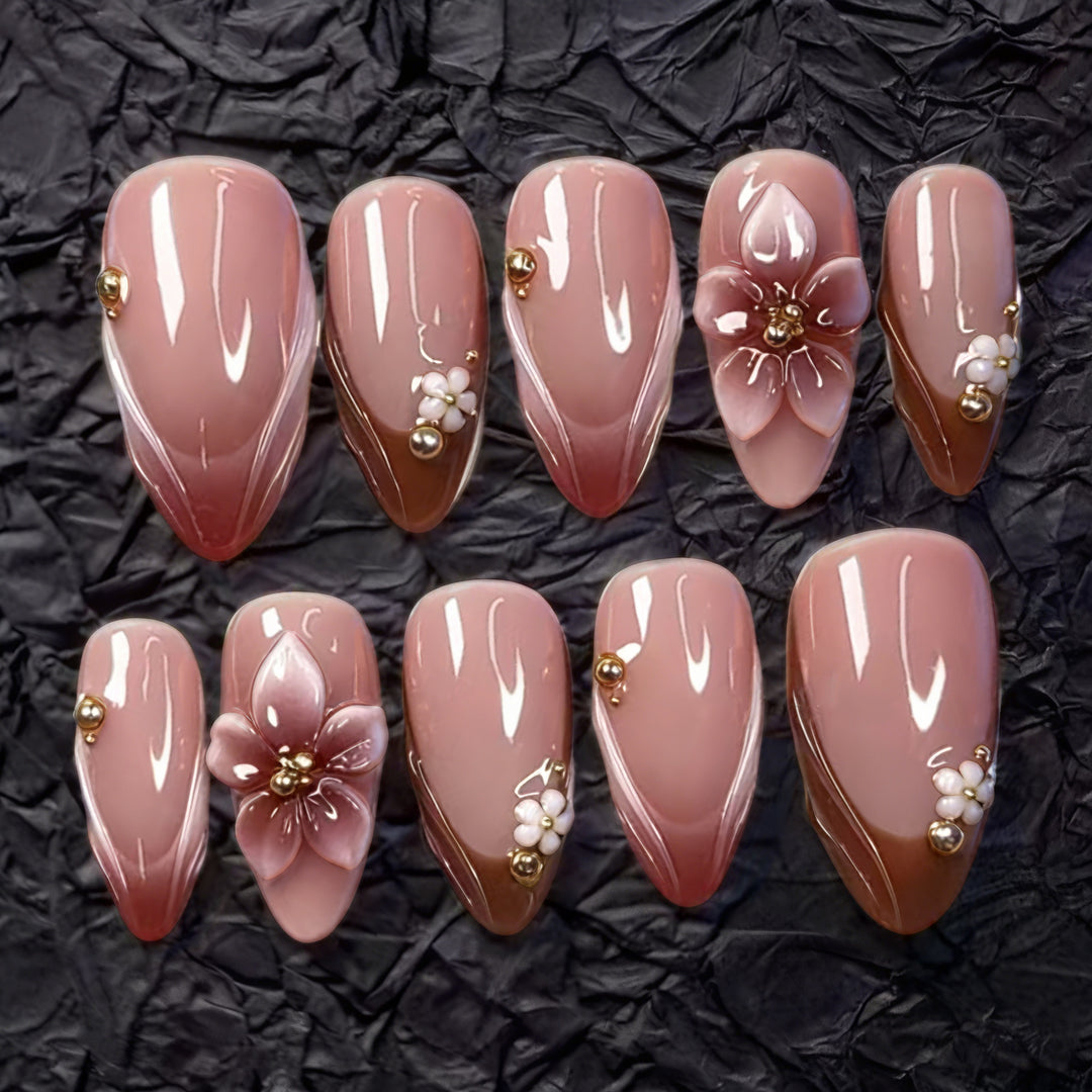 Artificial nail set with floral accents and gold embellishments Bowlift