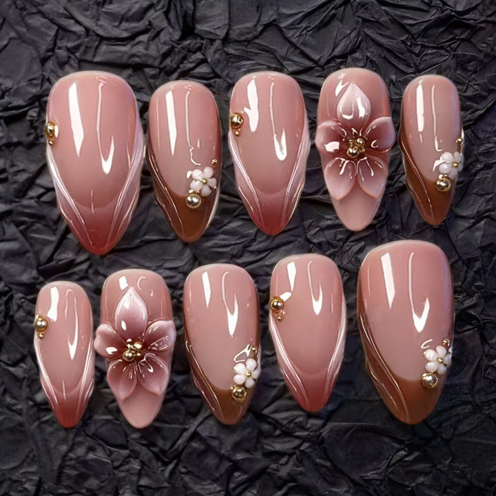 Artificial nail set with floral accents and gold embellishments Bowlift