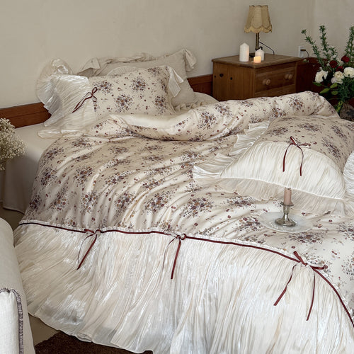 Romantic satin bedding set with ruffled edging, floral jacquard, and decorative ribbons Bowlift