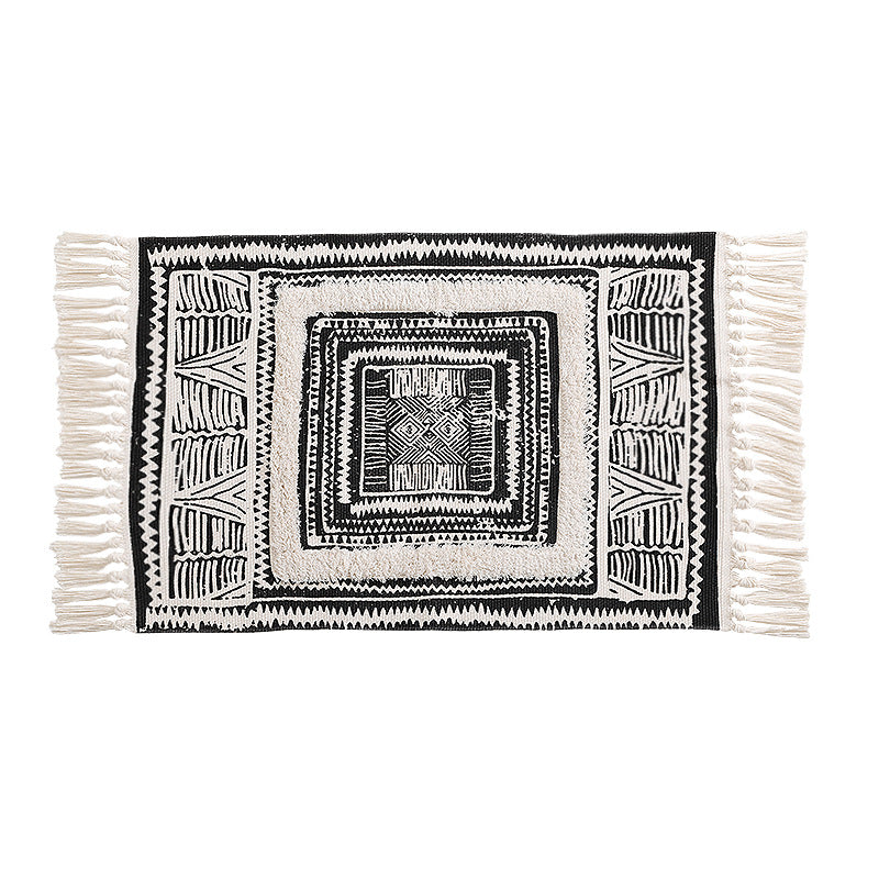 Flat Boho runner rug made of cotton blend fabric with geometric hexagon tufting and decorative fringed edge.