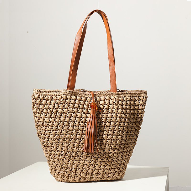 Handcrafted basket bag with fashionable tassel detail Bowlift