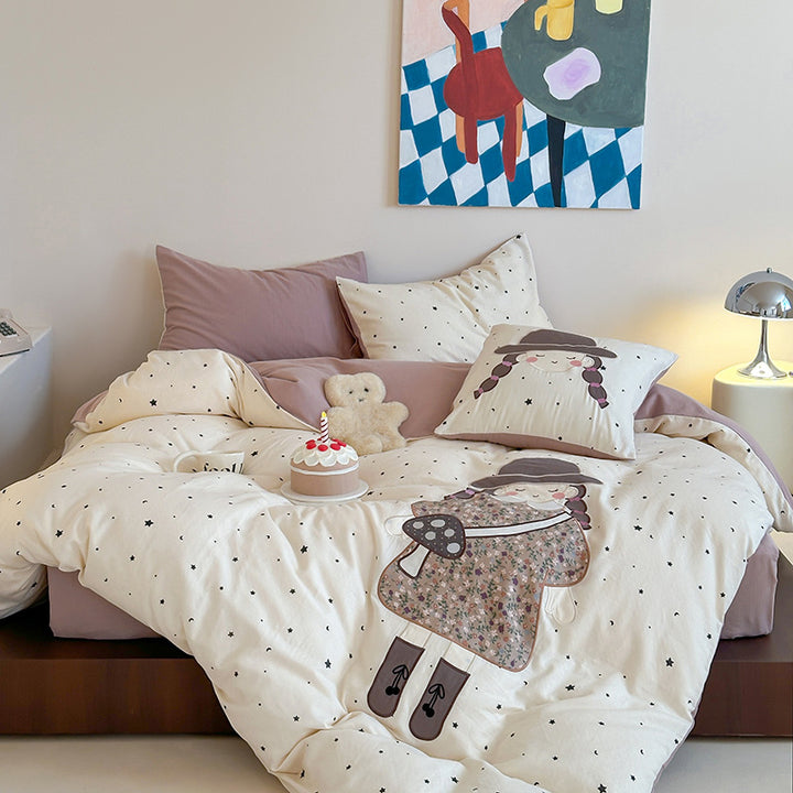 Bedding set with appliquéd doll motif and star pattern