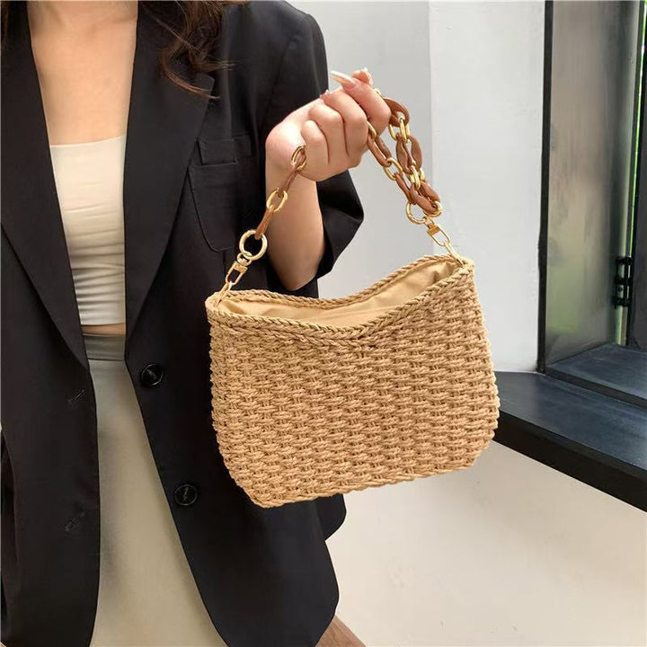 Handcrafted straw bag with golden chain details Bowlift
